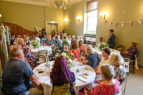Guests celebrating and listening to a speech by our Chair of Trustees, Jonathan Upton