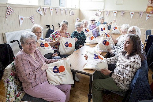 Lothian tea party guests with Re-engage 60th anniversary celebratory bags
