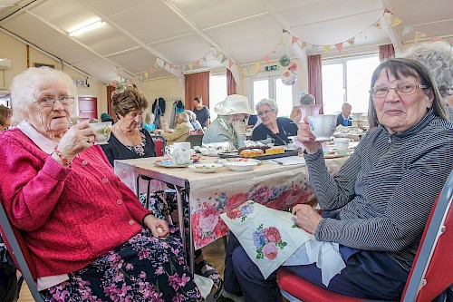 Royal Wootton Bassett tea party guests with tea and cakes