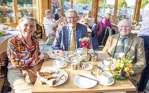 Tea party guests enjoying tea and cakes in Brechin
