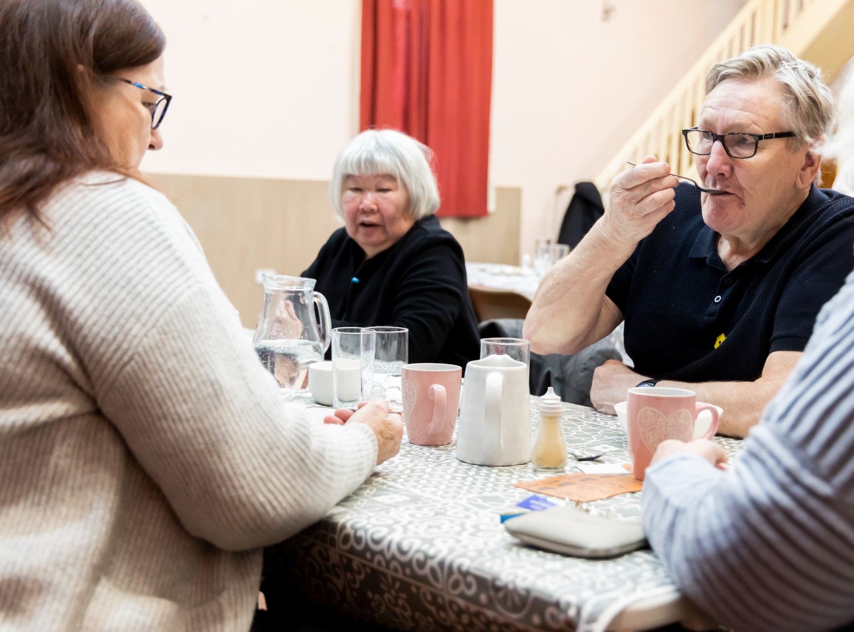People eating and drinking at a table