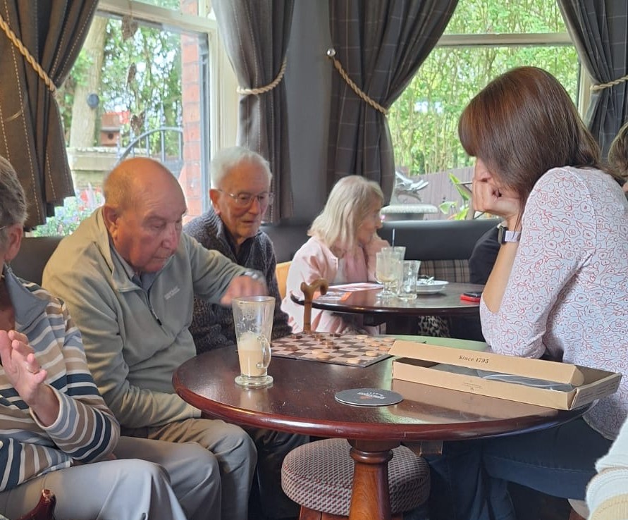 People playing a game sat at a table