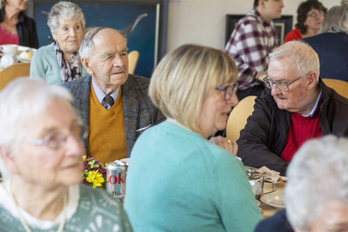 A group of people sat at tables